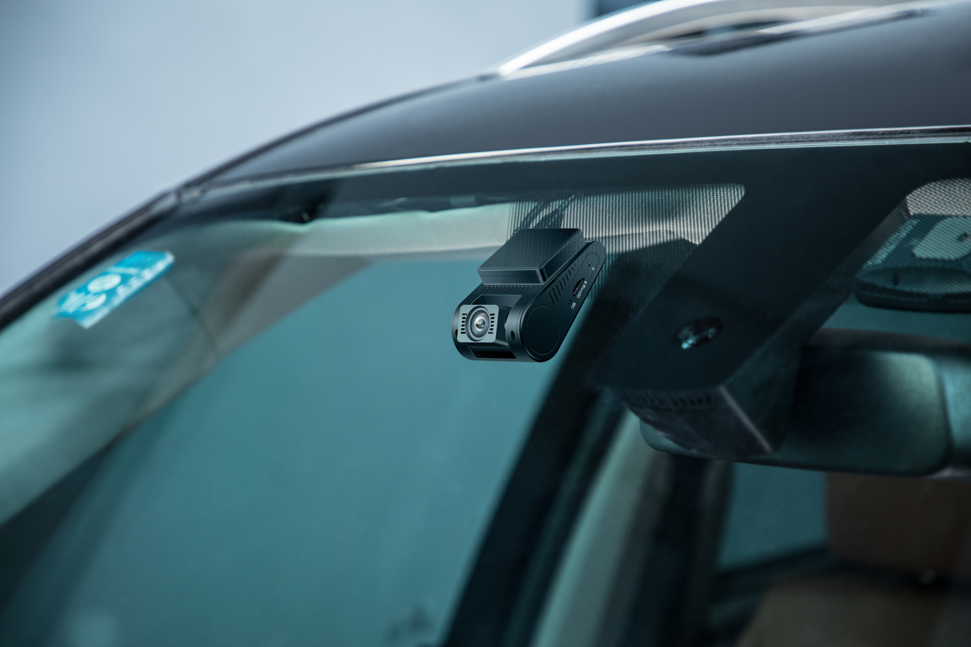 Car camera mounted on a car windshield with a blurred background