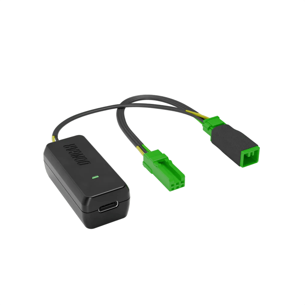 Black Dongar adapter with bright green plastic connectors and yellow-green internal wires, emphasizing plug-and-play interface for factory-look dash cam setup