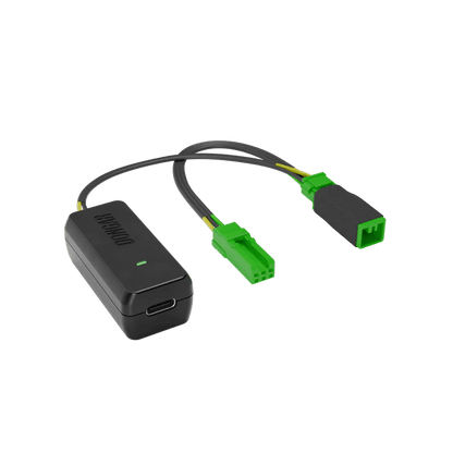Black Dongar adapter with bright green plastic connectors and yellow-green internal wires, emphasizing plug-and-play interface for factory-look dash cam setup