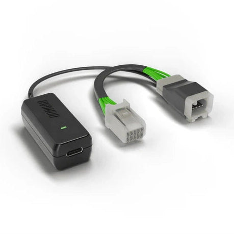 Dongar adapter with USB-C port connecting to gray multi-pin connector with exposed metal pins