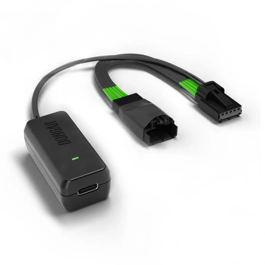 Dongar hardwire adapter with USB-C port and green LED, linked to Y-shaped harness with exposed metal pins and green-wrapped wires for secure connection