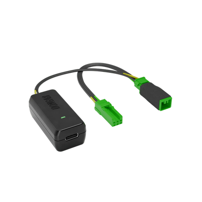 Black Dongar adapter with bright green plastic connectors and yellow-green internal wires, emphasizing plug-and-play interface for factory-look dash cam setup