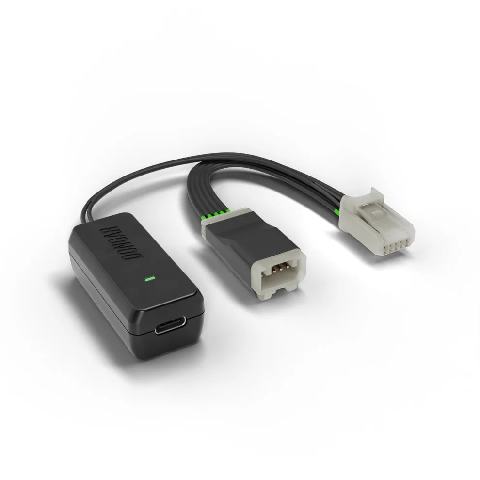 Compact Dongar hardwire module with green LED and copper pin connector, designed for easy plug-and-play mirror power without fuse taps or A-pillar runs