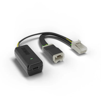Black Dongar adapter with USB-C port and gold contacts, paired with white 6-pin connector and visible green wire insulation for reliable dash cam power