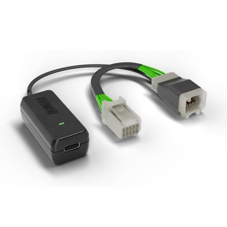 Dongar hardwire kit with 10-pin grid connector and open terminal cavity, displaying bright green conductors against white background for precise geometry view