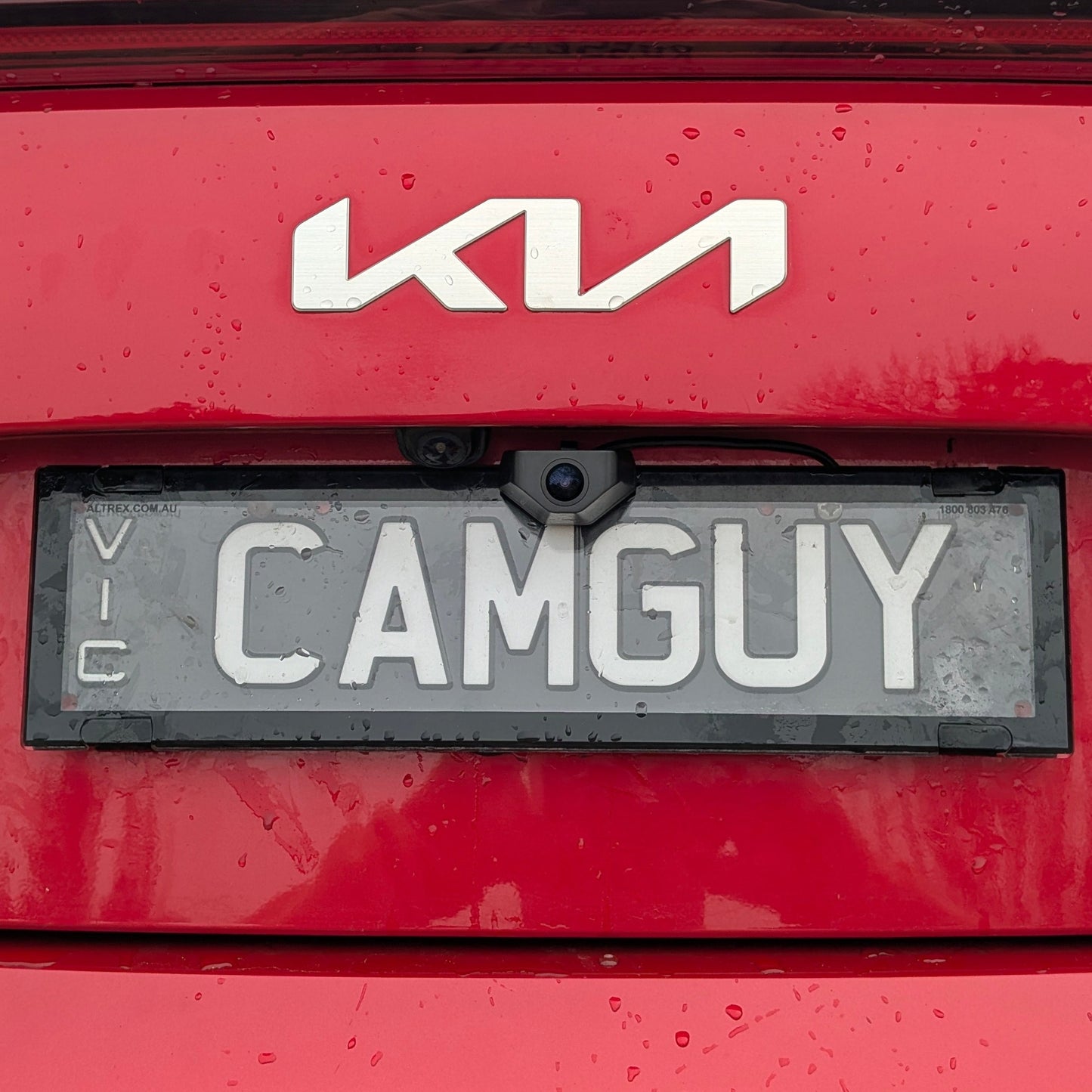 Close-up of Wolfbox camera bracket securing VIC license plate