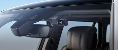 VIOFO T330T screenless dash cam mounted discreetly on car windshield near rearview mirror