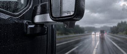 Waterproof exterior camera mounted on truck mirror in heavy rain