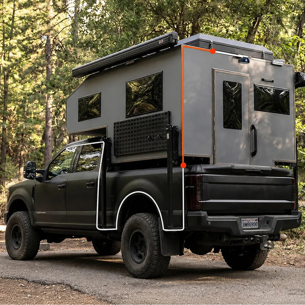 Rear camera extension cable routing on green pickup truck with camper