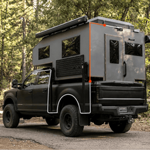 Rear camera extension cable routing on green pickup truck with camper