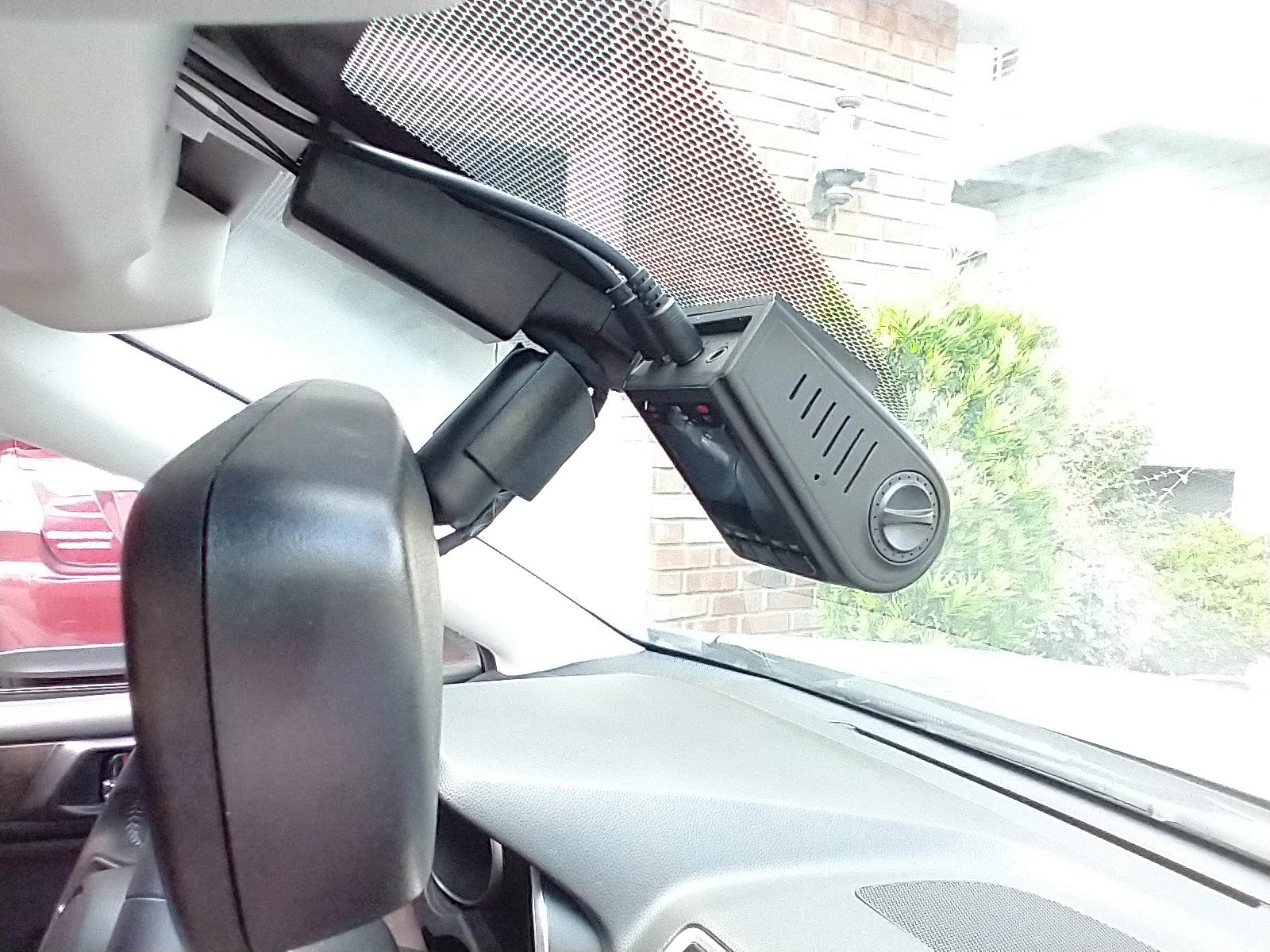 Car dashboard with a mounted GPS device and side mirror